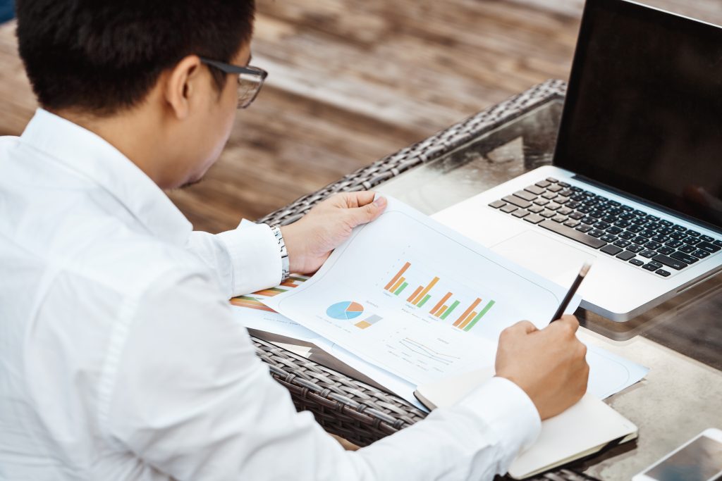 An image showcasing a professional working on financial reports, complemented by Singapore landmarks to localize the content.